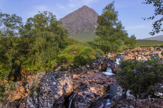 Morning view from Glen Etive over the water of River Coupall towards Buachaille Etive Mor in Glen Coe in the Highlands of Scotland.