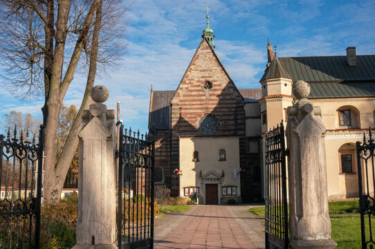 Gates are open, path leads to Church of Saint Florian and Assumption of Blessed Virgin Mary (kości&oacute;ł Świętego Floriana i Wniebowzięcia Najświętszej Maryi Panny), Cistercian Abbey. Wąchock, Poland.