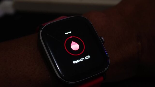 Close Up of Person Tapping Touchscreen Smartwatch to Measure Blood Oxygen SpO2 Level