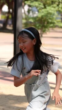 Happy Young Thai Girl Running and Playing at Lumpini Park Playground