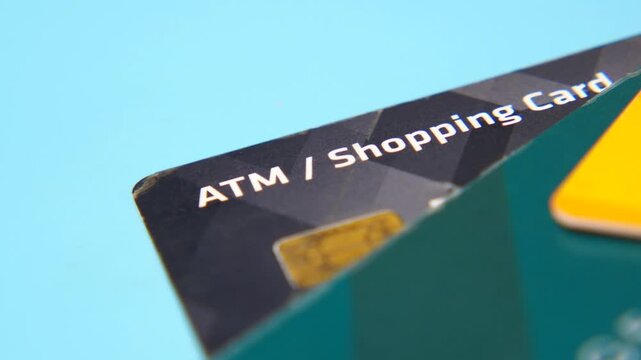 Close up of credit cards for atm and shopping transactions on blue background