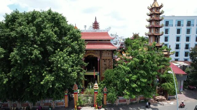 4k Aerial Drone shot of a beautiful pagoda Vinh Nghiem a Buddhist temple in Ho Chi Minh city next to a river canal in Vietnam