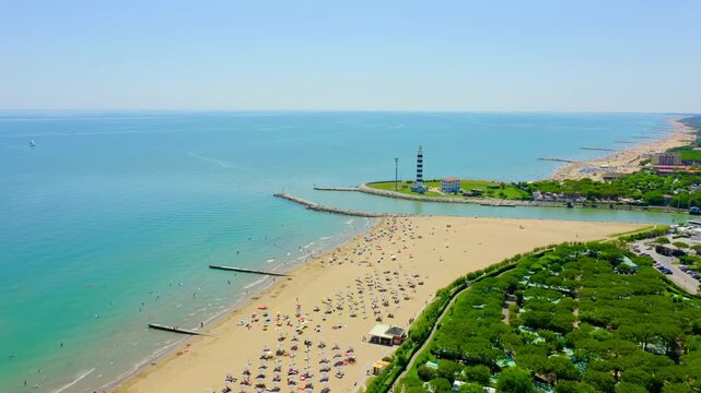 Italy, Jesolo. Faro di Piave Vecchia, a 48-meter black and white striped cylindrical lighthouse on a grassy river-mouth peninsula, Drone footage, Point of interest