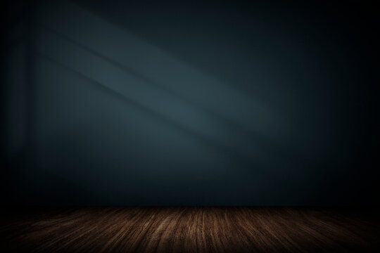 Empty dark room interior with wooden floor and blue wall with sunlight shadows for product display