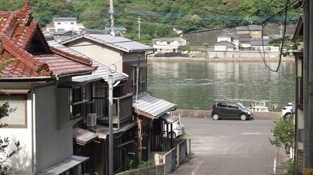 4K cinematic footage of a quiet coastal fishing village with traditional houses in Genkai, Saga, Japan