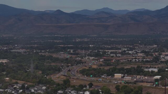Aerial of suburban valley and mountain range in Adams County Colorado along Interstate 76 in summer