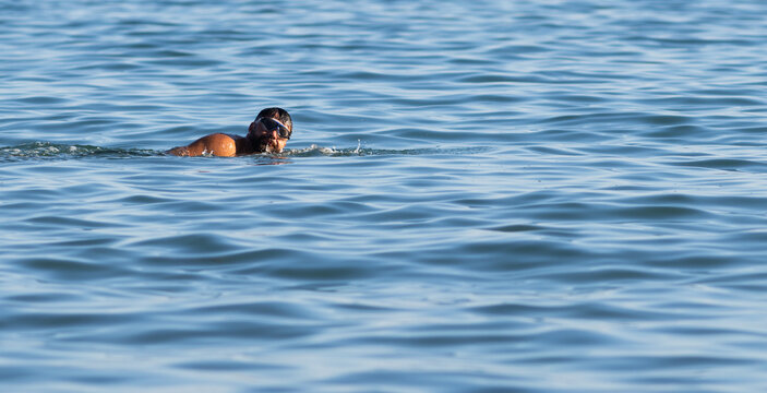 man swimming in the sea