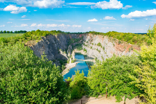 Velka Amerika limestone quarry lake surrounded by dramatic cliffs in the Czech Republic