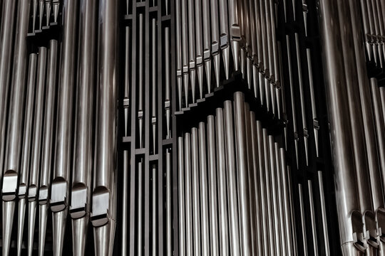 Close view of organ pipes arranged in a detailed pattern during a music performance