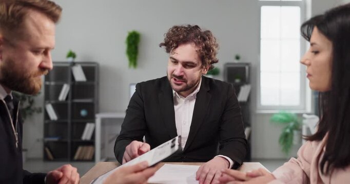Interview candidate with recruiters in office meeting. HR managers lead discussion, reviewing documents to assess experience and skills and role fit. Clear concept of hiring and recruitment.