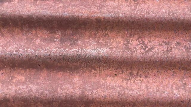 Corrugated Iron Texture: A close-up, full-frame shot showcases the weathered and rusted texture of corrugated iron, revealing its rough, undulating surface and earthy tones.
