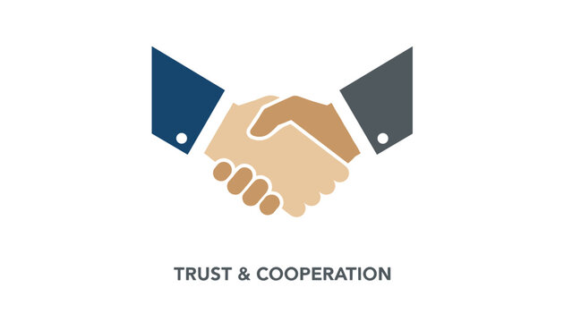 Handshake of diverse business hands beneath trust and cooperation text representing successful partnership agreement.