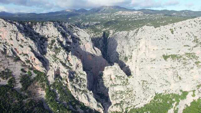 Stunning aerial view flying over Gorropu Gorge, a deep and majestic canyon located in the Supramonte mountains of Sardinia, Italy