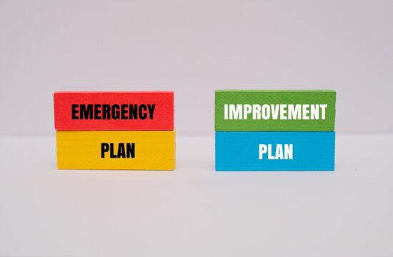 "EMERGENCY PLAN, IMPROVEMENT PLAN" text on colorful wooden blocks isolated on white background. Business decision and strategy concept