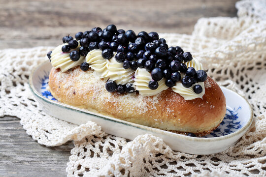 Delicious sweet yeast bun filled with smooth custard cream and topped with fresh blueberries.