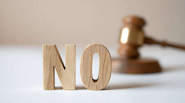 Wooden letters spelling the word no with a judge gavel in the background, legal concept, refusal, rejection, court decision and justice