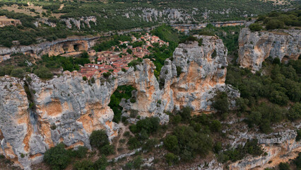 Fototapeta premium serene rock formations in a mountainous village viewed from above, showcasing nature's majestic beauty and tranquil atmosphere, Risco los camellos, Cascada de Orbaneja del Castillo