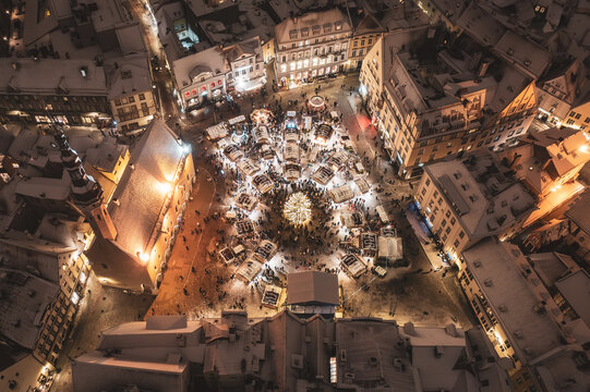 Aerial night View of Tallinn with the Town Hall Square in winter, roofs with snow, Christmas mood