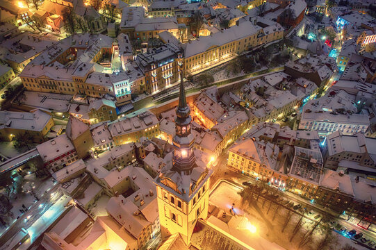 Aerial night View of Tallinn in winter, roofs are covered with snow, Christmas mood