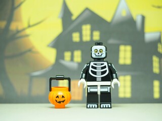 Fototapeta premium Indonesia - September 11, 2023 : Mini toy of action figure at table with blurred background. Halloween party concept design. Skeleton character