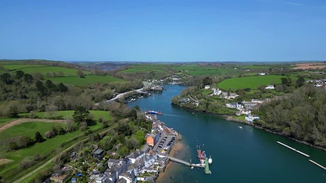 Fowey, Cornwall, England: DRONE VIEWS: A high angle shot of the town of Fowey, the River Fowey and the Fowey-Bodinnick ferry crossing the river. Cornwall is a popular UK holiday destination.