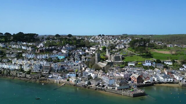 Fowey, Cornwall, England: DRONE VIEWS: The drone circles over the River Fowey showing the riverside town of Fowey. Fowey is a popular UK holiday spot and an important port for the export of china clay
