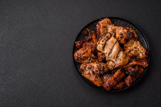 Grilled meat set featuring chicken breast, wings, and ribs seasoned with spices. Grilled meat set