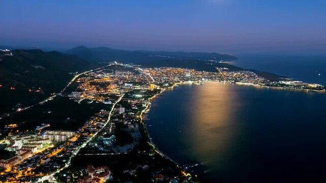 Gelendzhik, Russia. Night view of Gelendzhikskaya Bay. Fatty Mys. Night panorama of the city. Black Sea. Drone footage