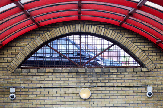 Staircase descent into underground pedestrian passage featuring a striking red spherical dome ceiling modern city urban architecture.