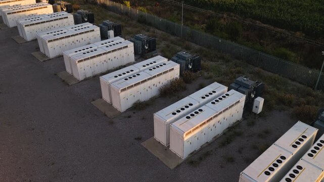 BESS Arrays at an Industrial Site Under Late Afternoon Sun
