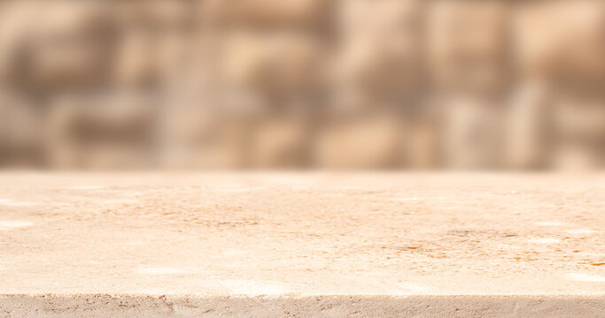 Textured stone surface with blurred background, ideal for product display or photography, showcasing natural patterns and colors in a neutral setting