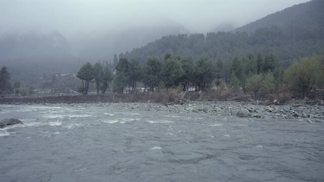 A Shot of Pahalgam Lidder River and Misty Himalayan Mountains Jammu and Kashmir India