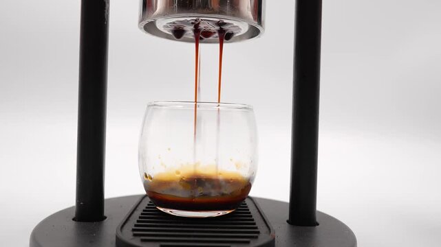  the manual machine a high end, manual lever style espresso maker . Americano dropping in clear glass. Preparation process.