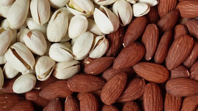 Pile of almonds and pistachio closeup footage