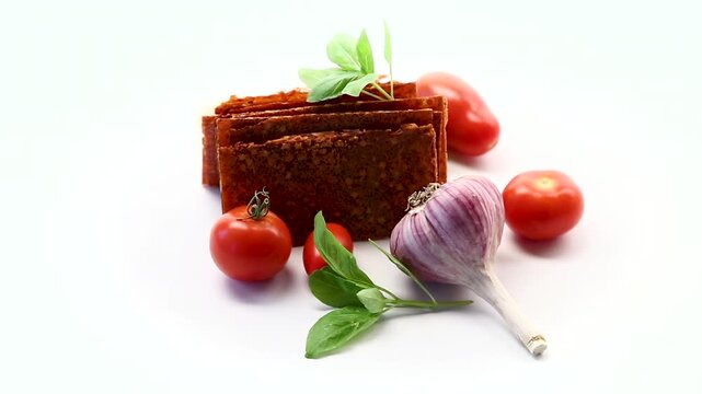 Spicy tomato pastila with garlic and basil on white background