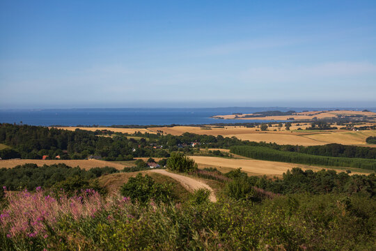 Panoramic view over rolling hills, fields and sea from Agri Bavneh&oslash;j in Mols Bjerge National Park