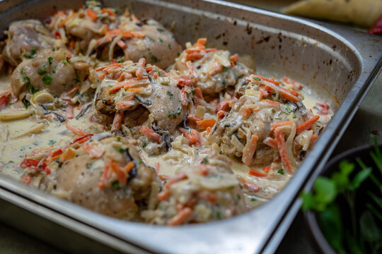 Beef stew with carrots and herbs in baking dish, traditional homemade dinner