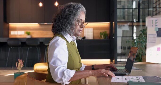 Remote work, document and woman with laptop in home, accountant or tax preparation with info on web. Freelance, senior bookkeeper and person with tech for budget, typing and financial report in house