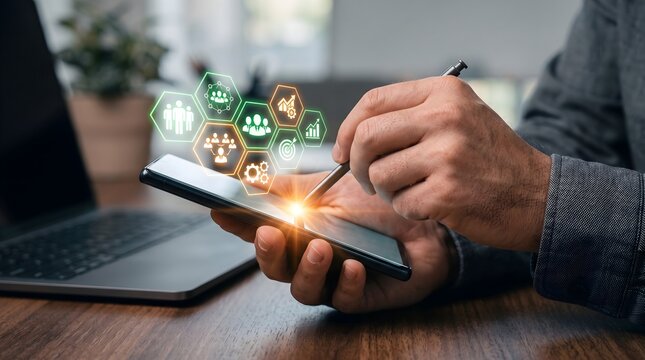 Businessman hands using stylus on mobile phone with virtual glowing icons of human resources and business strategy for digital transformation and enterprise growth