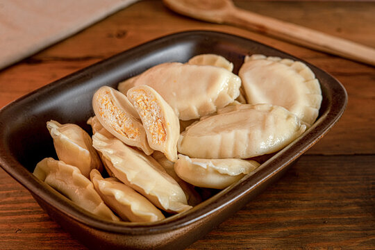 Traditional raw Polish pierogi dumplings filled with savory and sweet fillings on plate