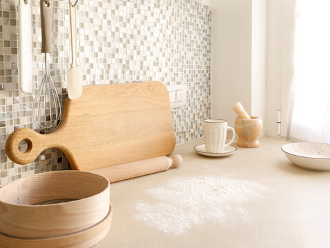Flour spilled on beige kitchen counter for baking preparation scene. 