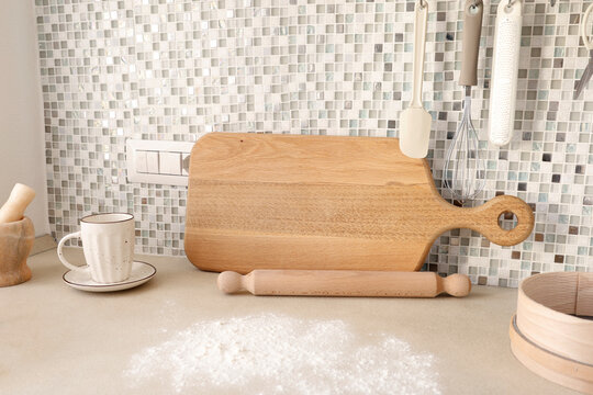 Flour spilled on beige kitchen counter for baking preparation scene. 