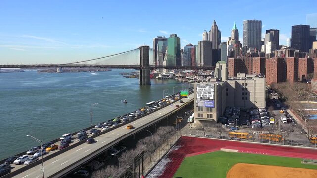 Brooklyn bridge and manhattan skyline view with traffic on fdr drive in new york city.