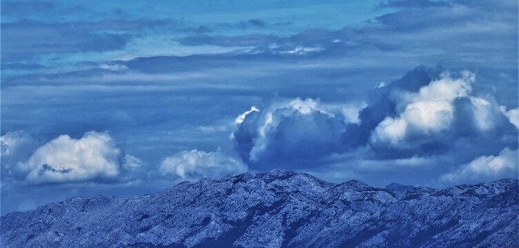 Clouds above the mountain sky background