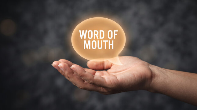 Open hand holding a glowing speech bubble with "WORD OF MOUTH" text, symbolizing communication and sharing.