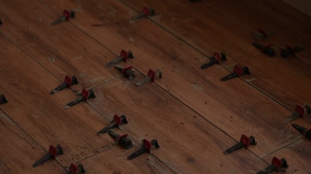 Instalation of ceramic tile on a floor. Floor leveling system. 4K