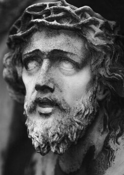 Close-up portrait of Jesus Christ wearing a crown of thorns, symbol of suffering, sacrifice and Christian faith.