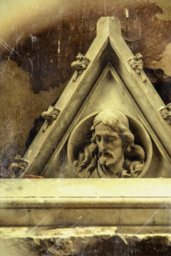 Statue of Jesus Christ on an old grave, symbol of Christian faith, death, resurrection and eternal life.