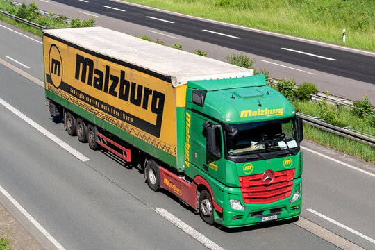Wiehl, Germany - May 26, 2026: Malzburg Mercedes-Benz Actros truck with tarpaulin trailer on motorway