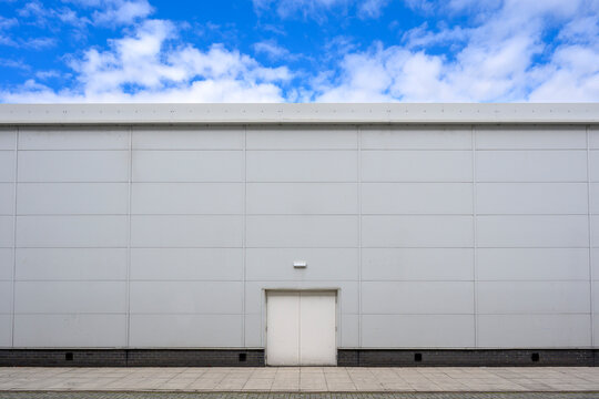 Minimalist facade of a white industrial building